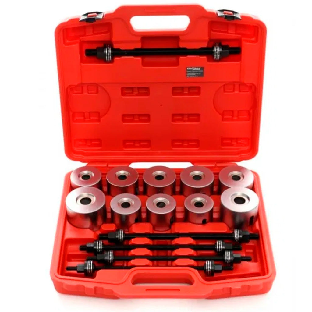 Zestaw do montażu i demontażu tulei w czerwonej walizce, z metalowymi tulejami i śrubami prowadzącymi do serwisowania zawieszenia pojazdów.